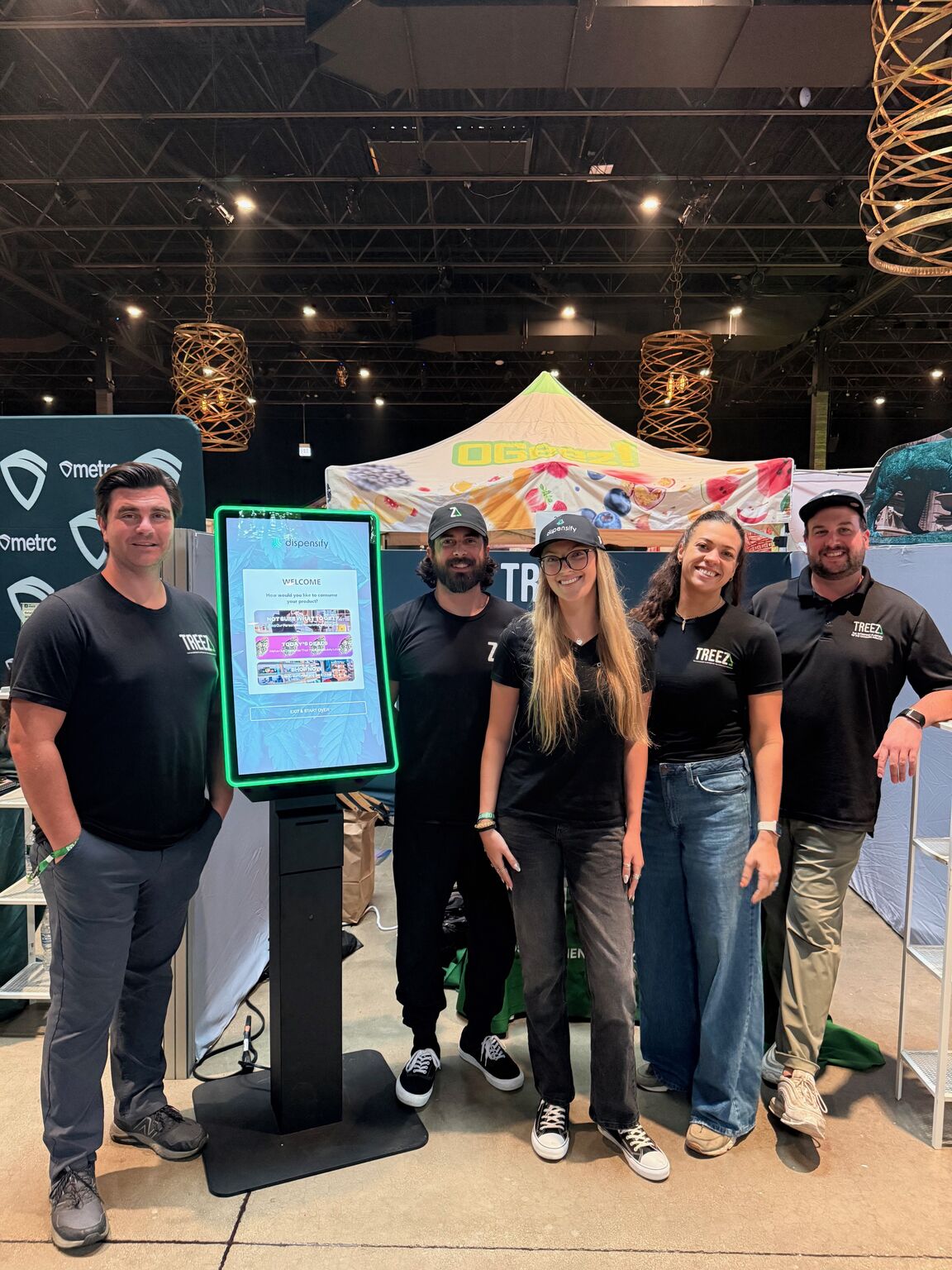 The Dispensify and Treez team beside a Giosk 32CF kiosk at Flower Expo Illinois